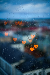 Heart-shaped city lights through window