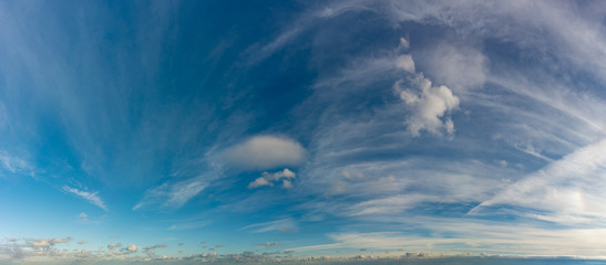 Fantastic clouds against blue sky, panorama