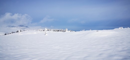 Fototapeta na wymiar winter landscape with mountains and blue sky