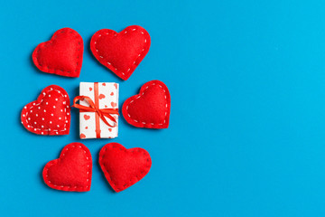 Top view colorful valentine background made of gift boxes and red textile hearts. Valentine's Day concept with copy space