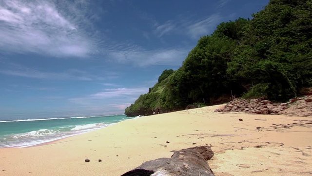 Beautiful tropical white sandy beach of Pantai Gunung Payung in Bali. wide view from action camera.