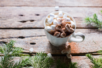 White cup of coffee with marshmallows and cocoa