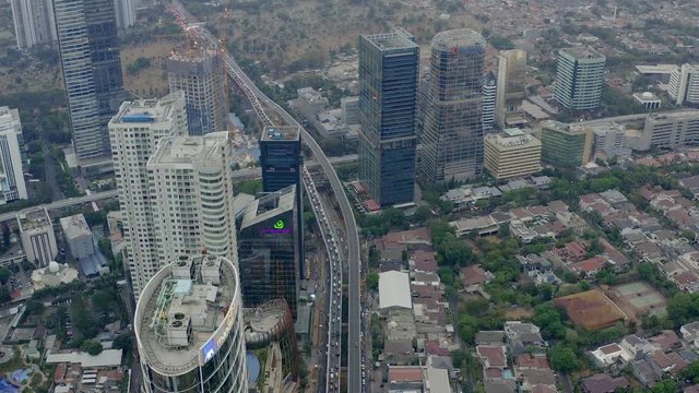 Top Down Aerial Aerial drone  view of Jakarta city skyscrapers during the afternoon under cloudy day. Reveal Wide shot on 4K DJI Mavic 2
