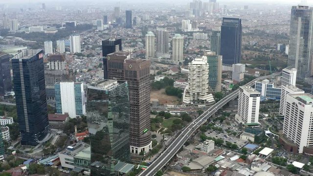 Aerial panorama view of cityscape of Jakarta before sunset. Bird eye view from Drone with tilt down motion showing traffic