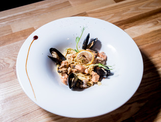 Pasta with mussels in pan. Italian style cuisine. Restaurant.