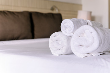 Fototapeta na wymiar White hotel towel on bed,Stack of fluffy bath towels,Close up,Copy space for text
