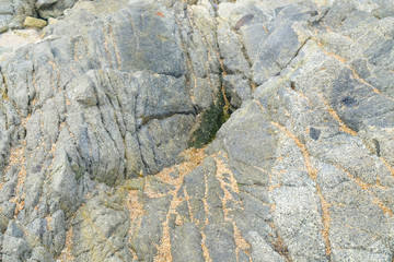 Granite rock in medieval wall background and texture, close-up.
