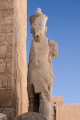 Karnak temple complex in Luxor, Egypt. Broken statue of pharaoh.