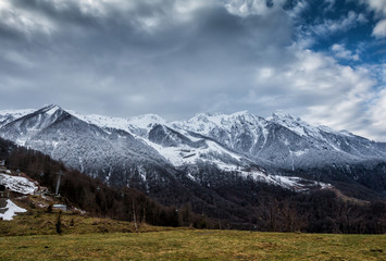 High mountain peaks covered with snow on a winter cloudy day