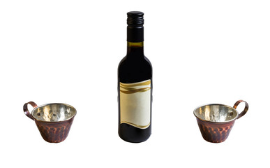 Two copper cups and bottle of wine on white isolated background.
