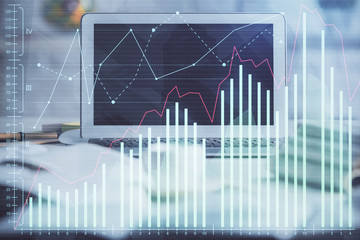 Financial graph colorful drawing and table with computer on background. Double exposure. Concept of international markets.