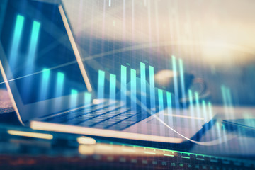 Financial graph colorful drawing and table with computer on background. Double exposure. Concept of international markets.