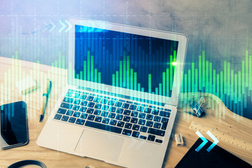 Double exposure of forex graph and work space with computer. Concept of international online trading.