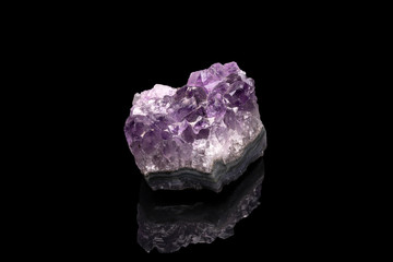 Purple rough Amethyst quartz crystals geode isolated on black