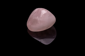Raw rose quartz isolated on black background. Macro shot.