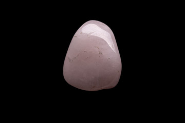 Raw rose quartz isolated on black background. Macro shot.