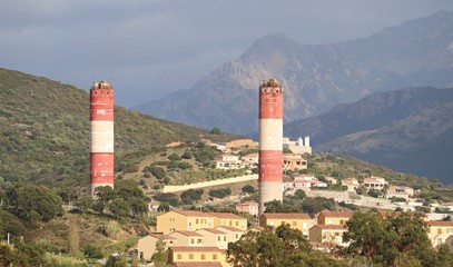 Fototapeta na wymiar Two industrial pipes rise high on the outskirts of Ajaccio on the island of Corsica. France, September 2019
