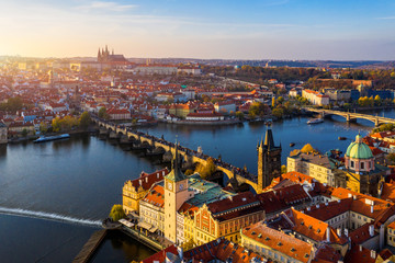 Aerial Prague panoramic drone view of the city of Prague at the Old Town Square, Czechia. Prague Old Town pier architecture and Charles Bridge over Vltava river in Prague at sunset, Czech Republic.