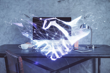 Fototapeta na wymiar Desktop computer background in office and handshake hologram drawing. Double exposure. Pertnership concept.