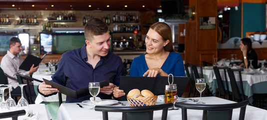 Couple and reading menu in restaurant