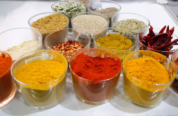 Set of indian spices in glass cups at the market.