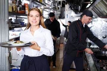 Portrait of waitress at restaurant kitchen