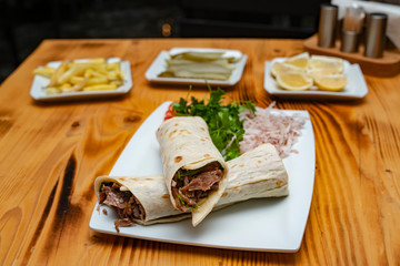 close up of kebab sandwich on wooden background