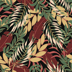 Fashionable seamless tropical pattern with bright green and yellow plants and leaves on a dark background. Jungle leaf seamless vector floral pattern background. Exotic tropics. Summer.