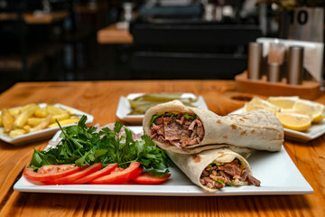 close up of kebab sandwich on wooden background