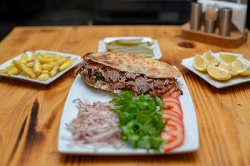close up of kebab sandwich on wooden background