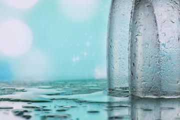Background with tall glasses for sparkling wines. Champagne and spray in glass glasses. Celebratory drink with reflection.