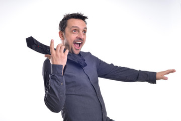 Portrait of a young dude isolated on white, wearing a grey shirt and a black tie acting excited, surprised, pulling faces .