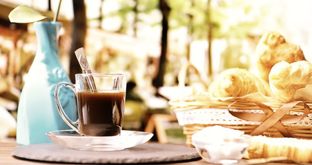 Fresh pastries on the table. French flavored croissant and coffee.