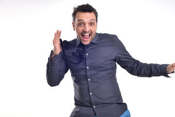 Fototapeta premium Portrait of a young dude isolated on white, wearing a grey shirt and a black tie acting excited, surprised, pulling faces .