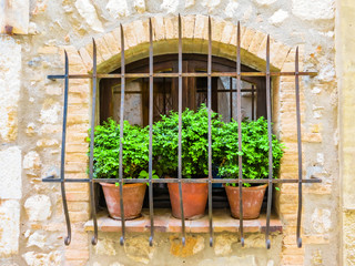 Fototapeta na wymiar Old window in medieval wall. Saint-Paul de Vence, France