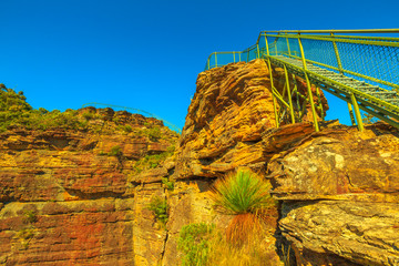 Fototapeta na wymiar Stairway leading up to Pulpit Rock lookout famous landmark in Blue Mountains National Park, New South Wales, Australia. Sandstone rock and cliff rock views.