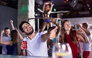 Female and male in the night club