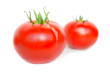 Two red fresh tomatoes isolated on white background