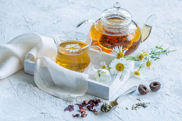 Chamomile tea in a glass teapot