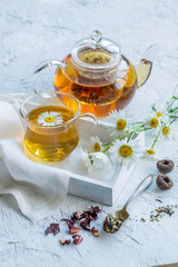 Chamomile tea in a glass teapot