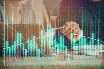 Forex graph with businessman typing on computer in office on background. Concept of analysis....