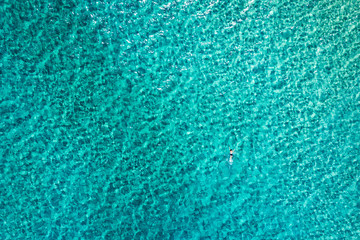 People swimming in the sea. Aerial view, Top view. The color of the water and beautifully bright. Swimming and relaxing in the sea blue lagoon aerial top view. Top view from flying drone.