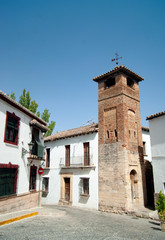 Minaret of San Sebastian, Ronda, Spain.  Originally part of a mosque. A square tower. The lower part in stone with a  horseshoe, alfiz arch, the middle in brick and the upper part a belfry. 