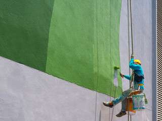Painters painting exterior of building