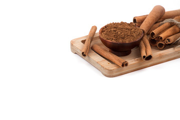 Cinnamon sticks and powder, isolated on white background