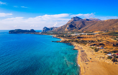 Fototapeta na wymiar Aerial shot of beautiful turquoise beach Falasarna (Falassarna) in Crete, Greece. View of famous paradise sandy deep turquoise beach of Falasarna (Falassarna) in North West, Crete island, Greece.