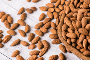 Almonds nut on white wooden table. Almond healthy raw food.