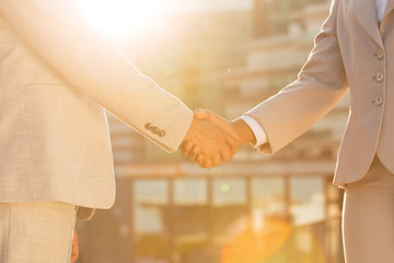 Business partners greeting each other near office building in morning. Closeup of business man and...