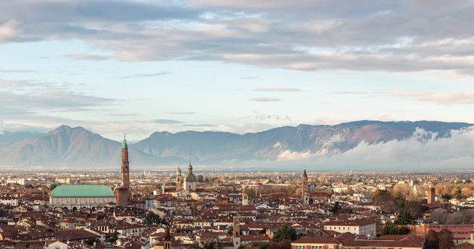 Aerial view of the city of Vicenza in Italy at sunset. The city of Palladio, from the name of the architect who designed most of his works here in the late Renaissance. Sky clearing after a rainy day.