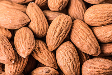 Almonds nut on white wooden table. Almond healthy raw food background.